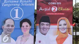 Sejumlah pekerja melakukan pemasangan Alat Peraga Kampanye Pemilihan Walikota dan Wakil Walikota Tangerang Selatan Tahun 2015 di Bundaran Maruga, Tangerang Selatan, (2/9/2015). (Liputan6.com/Helmi Afandi) 
