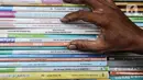 Pedagang memeriksa buku dagangannya di kawasan Kwitang Jakarta, Jumat (26/6/2020). Sejumlah pedagang mengaku penjualan buku mengalami penurunan hingga 50 persen karena imbauan Pemerintah untuk tinggal dirumah dan libur sekolah selama pandemi COVID-19. (Liputan6.com/Faizal Fanani)