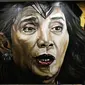 Gambar mural Menteri Kelautan dan Perikanan, Susi Pudjiastuti, bergaya Wonder Woman di tembok di Jalan Slamet Riyadi, Solo, Jawa Tengah. (Liputan6.com/Fajar Abrori)