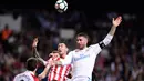 Pemain Athletic Bilbao, Ander Iturraspe dan Oscar De Marcos berebut bola dengan pemain Real Madrid, Sergio Ramos pada pekan ke-33 La Liga di Santiago Bernabeu, Rabu (18/4). Madrid harus puas bermain imbang 1-1 lawan Athletic Bilbao. (JAVIER SORIANO/AFP)