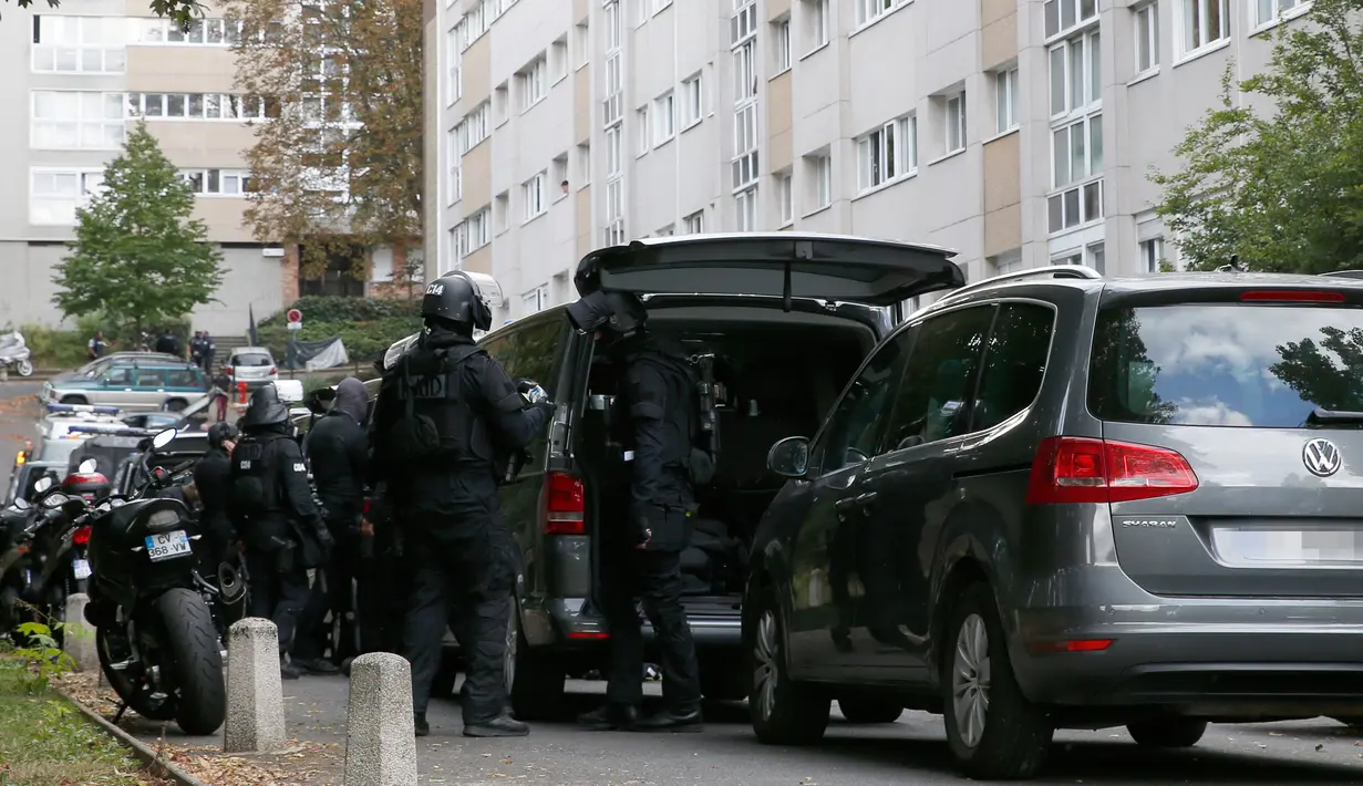 RAID (satuan polisi elit) mengepung sebuah bangunan tempat tinggal pelaku penembakan di supermarket Kota Port-Marly, dekat Paris, Senin (26/9). Kakek itu menembak kasir berusia 57 tahun dan pria berusia 73 tahun sebelum melarikan diri. (Thomas Samson/AFP)