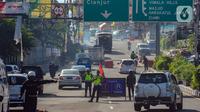 Sistem ganjil genap diterapkan untuk mengantisipasi macet libur cuti bersama Hari Raya Idul Adha. Sistem ini akan diterapkan hingga 2 Juli 2023. Kendaraan yang melintas disesuaikan pelat nomornya dengan tanggal. (merdeka.com/Arie Basuki)