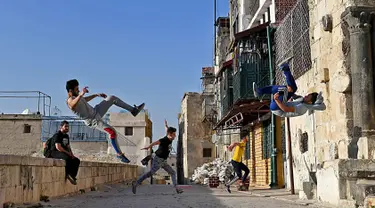 Pemuda Suriah berlatih parkour di Aleppo, Suriah utara, (7/4). Setelah pemerintah Suriah mengambil alih kendali penuh Aleppo dari pasukan pemberontak Desember 2016, beberapa pemuda kini menyalurkan hobinya, yaitu parkour.  (AFP Photo/George Ourfalian)