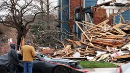 Warga saat melihat reruntuhan rumah yang disapu oleh angin tornado di Texas, Amerika Serikat, (28/12). Bencana ini juga menewaskan 8 orang yang sedang berkendara di jalanan kota Garland. (REUTERS/Todd Yates)