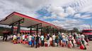 Orang-orang mengantre untuk mendapatkan bensin setelah Badai Helene pada Minggu 29 September 2024 di Fletcher, Carolina Utara. (Sean Rayford/Getty Images North America/Getty Images via AFP)