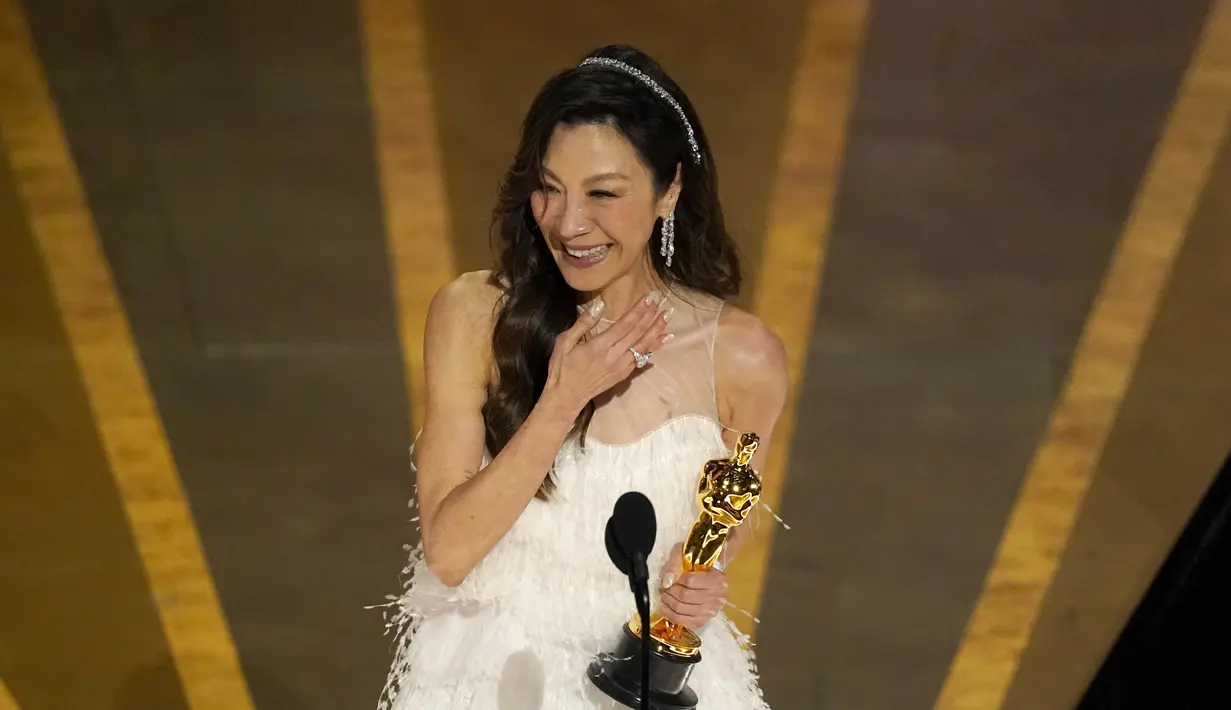 Aktris Michelle Yeoh menerima penghargaan untuk kategori  aktris terbaik (Actress in Leading Role) dalam acara malam puncak Academy Awards ke-95 di The Dolby Theatre Los Angeles, Minggu (12/3/2023). Michelle Yeoh meraih Piala Oscar kali pertama di usia 60 tahun. (AP Photo/Chris Pizzello)