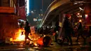 Polisi antihuru-hara tiba setelah demonstran membakar sampah di Hong Kong, Minggu (29/9/2019). Demonstrasi pada akhir pekan ini sendiri digelar beberapa hari menjelang perayaan kemerdekaan China. (AP Photo/Vincent Yu)