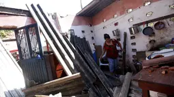 Seorang wanita melihat rumahnya yang rusak parah akibat terkena Badai Patricia, Meksiko, Sabtu (24/10/2015). Pusat Badai Nasional AS di Miami mengatakan badai tersebut  berada pada level 5 atau dengan kecepatan angin 265km/jam. (Reuters/Henry Romero)