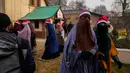 Sekelompok wanita Muslim Kashmir yang mengenakan topi Sinterklas pergi setelah berpartisipasi dalam doa Natal di Gereja Katolik Keluarga Kudus, Srinagar, Kashmir, India, Minggu (25/12/2022. Meski umat Kristen adalah komunitas minoritas, 25 Desember adalah libur nasional di India. (AP Photo/Mukhtar Khan)