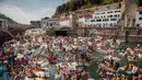 Ribuan orang berdatangan mendayung perahu rakitan buatan mereka di pelabuhan kota Basque San Sebastian utara selama (12/8).  Acara ini menghadirkan Pesta, Konser, Acara berperahu bertema bajak laut Dan kembang api malam. (AFP Photo/Gari Garaialde)