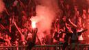 Suporter PSS Sleman menyalakan flare saat melawan Semen Padang pada laga Liga 2 di Stadion Pakansari, Jawa Barat, Selasa (4/12). PSS menang 2-0 atas Semen Padang. (Bola.com/M. Iqbal Ichsan)