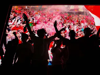 Pendukung Turki merayakan kemenangan setelah menyaksikan pertandingan babak 16 besar melawan Austria di Euro 2024 yang dimainkan di Leipzig, Jerman, Selasa, 2 Juli 2024 atau Rabu 7 Juli 2024 dini hari WIB, di distrik Beyoglu, Istanbul. (AP Photo/Khalil Hamra)