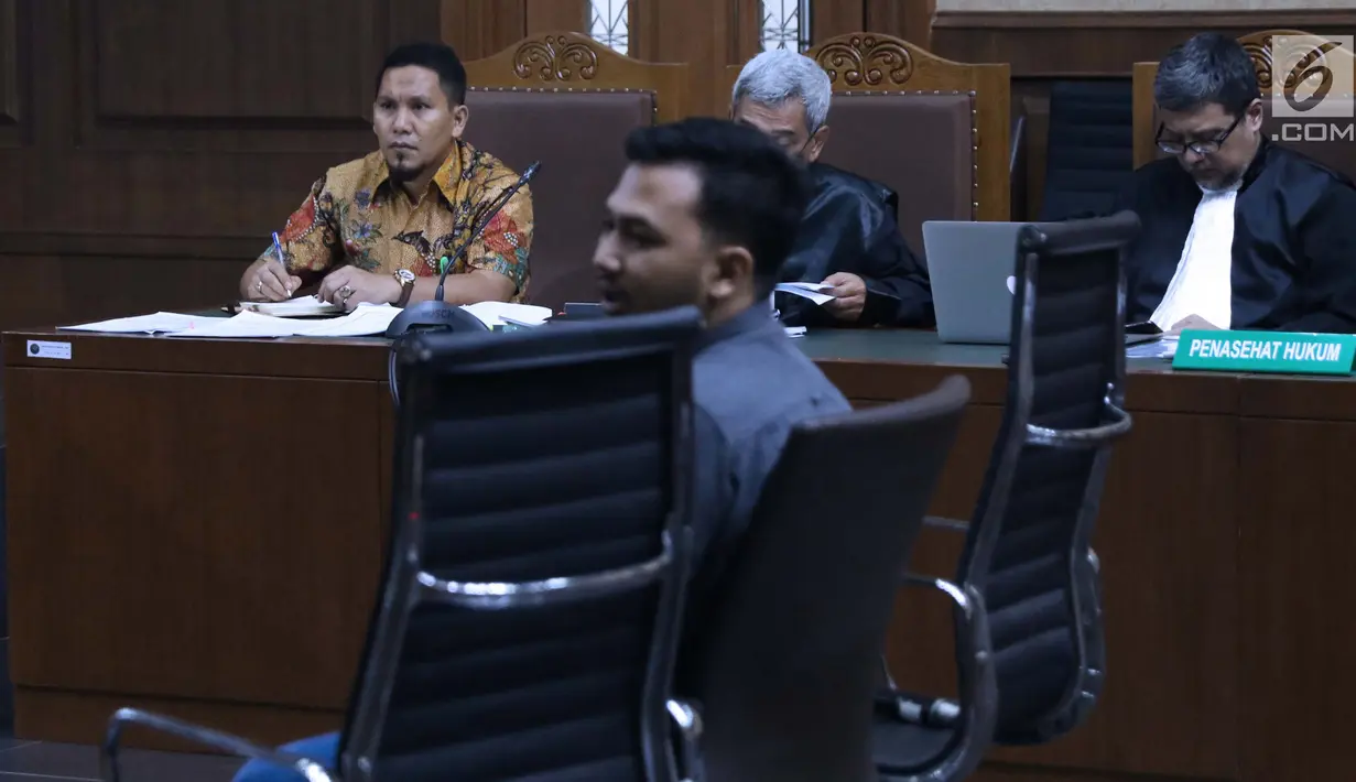 Bupati nonaktif Bener Meriah, Ahmadi (kiri) menyimak keterangan saksi saat menjalani sidang lanjutan dugaan suap alokasi dan anggaran Dana Otonomi Khusus Aceh di Pengadilan Tipikor, Jakarta, Senin (15/10). (Liputan6.com/Helmi Fithriansyah)