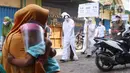 Petugas Kecamatan Larangan berkeliling mengenakan pakaian pocong saat melakukan sosialisasi di Pasar Cipadu, Kota Tangerang, Rabu (16/9/2020). Sosialisasi dengan pocong tersebut dilakukan agar masyaraka dapat memahami bahaya COVID-19. (Liputan6.com/Angga Yuniar)