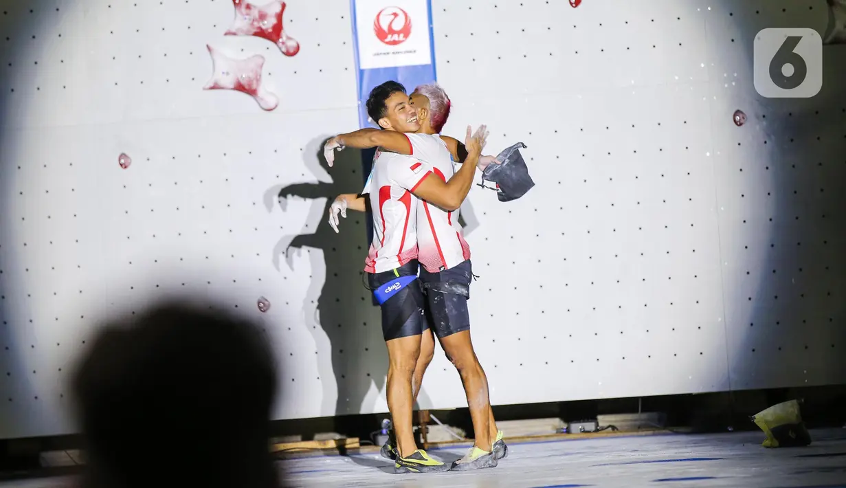 Atlet panjat tebing Indonesia Aspar Jailolo (kanan) memeluk atlet panjat tebing Indonesia Kiromal Katibin usai meraih kemenangan final kategori speed dalam Kejuaran Dunia Panjat Tebing 2022 (International Federation of Sport Climbing/IFSC) di Jakarta, Sabtu (24/9/2022). Aspar berhasil mengalahkan lawan yang juga kompatriotnya, Kiromal Katibin. Catatan waktu Aspar adalah 5,39 detik. (Liputan6.com/Faizal Fanani)