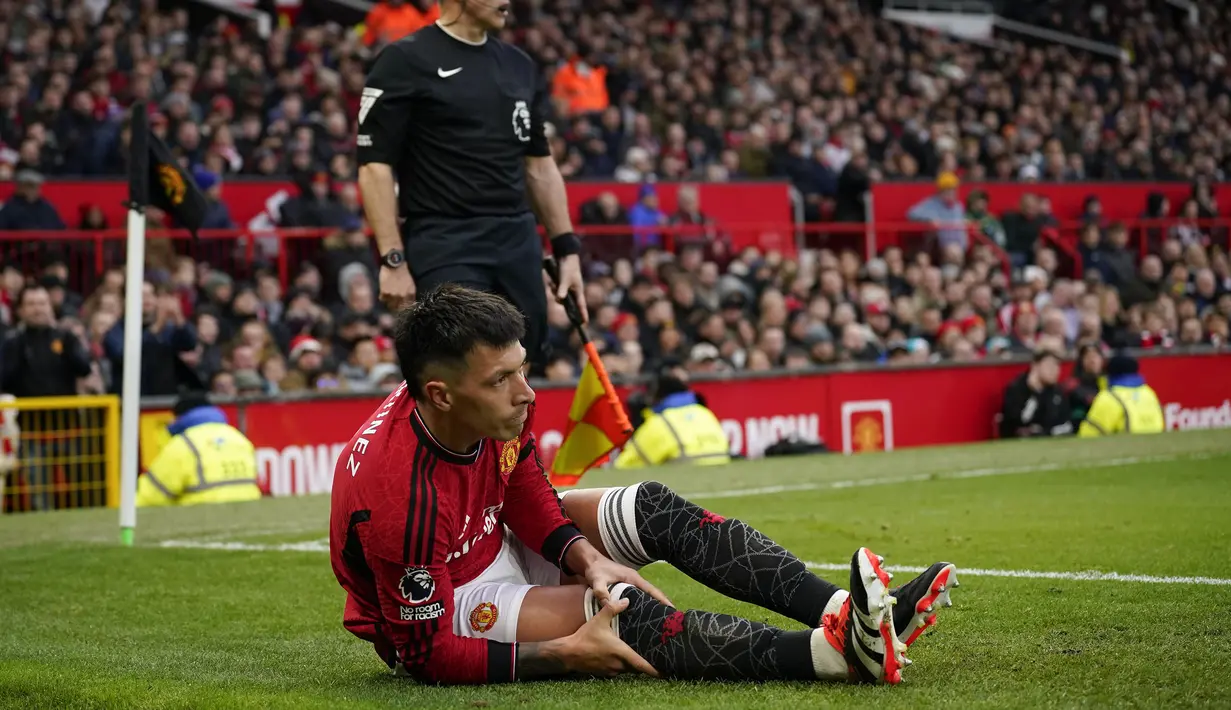 Pemain Manchester United, Lisandro Martinez memegangi lututnya saat laga lanjutan Liga Inggris 2023/2024 antara Manchester United melawan West Ham United di Old Trafford, Manchester, Inggris, Minggu (04/02/2024). (AP Photo/Dave Thompson)