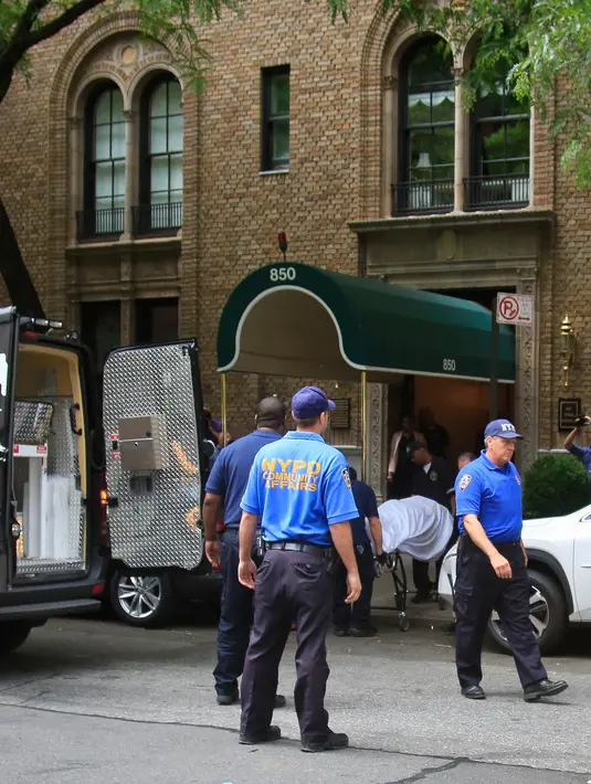 Petugas medis memindahkan jasad desainer ternama Kate Spade menuju mobil ambulans dari apartemennya di Park Avenue, New York. Selasa (5/6). Kabarnya, Kepolisian New York (NYPD) menemukan sebuah surat dari Kate Spade di TKP. (AP Photo/Bebeto Matthews)