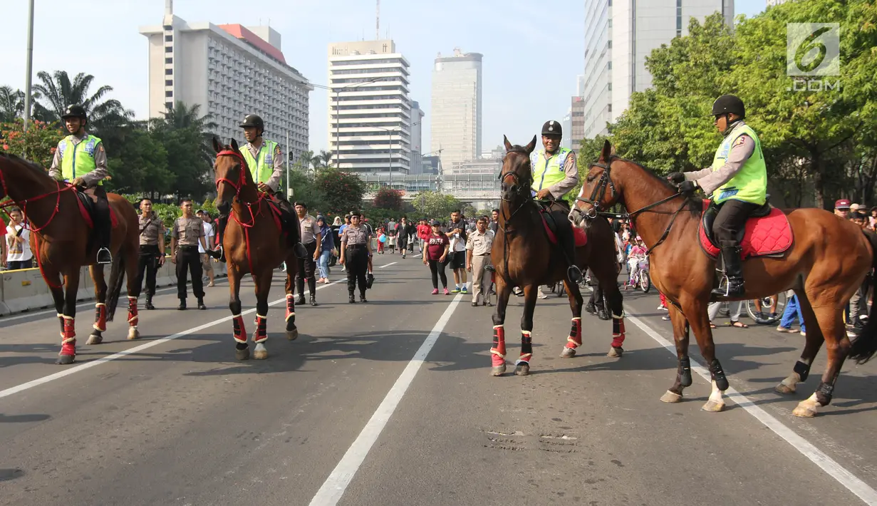 Polisi berkuda mengamankan Parade Asian Games 2018 di Jalan Thamrin, Jakarta, Minggu (13/5). Sejumlah pejabat negara hadir seperti Wakil Presiden RI Jusuf Kalla, Gubernur DKI Anies Baswedan dan Ketua Inasgoc, Erick Thohir.  (Liputan6.com/Arya Manggala)