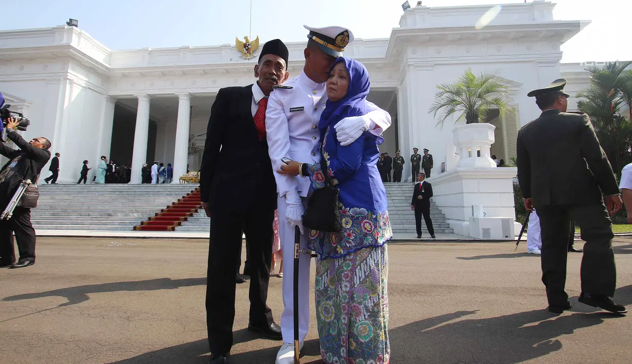 Seorang Perwira Remaja menangis sambil memeluk keluarganya usai dilantik Presiden Joko Widodo, di Istana Merdeka, Jakarta, Selasa (25/7). Dalam acara ini Jokowi melantik 729 orang Calon Perwira Remaja (Capaja) TNI-Polri. (Liputan6.com/Angga Yuniar)