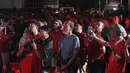 Para suporter Indonesia ikut berdiri menyanyikan lagu kebangsaan Indonesia Raya saat acara nonton bareng laga perebutan tempat ketiga Piala Asia U-23 2024 antara Timnas Indonesia U-23 menghadapi Irak di Plaza Kemenpora, Senayan, Jakarta Pusat, Kamis (2/5/2024) malam WIB. (Bola.com/Afi)