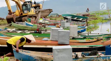 Kotak suara aluminium digunakan untuk menutupi mesin perahu nelayan di Danau Limboto, Gorontalo, Sabtu (26/1). Nalayan menggunakan kotak suara aluminium tersebut agar mesin terjaga dari hujan dan panas. (Liputan6.com/Arfandi Ibrahim)