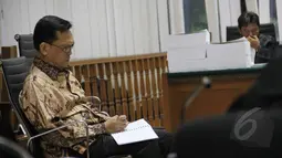 Terdakwa kasus dugaan korupsi simulator SIM yang juga mantan Wakil Kepala Korlantas Brigjen Pol Didik Purnomo terlihat menulis catatan saat menjalani sidang pembacaan tuntutan di Pengadilan Tipikor, Jakarta, Senin (16/3/2015). (Liputan6.com/Helmi Afandi)