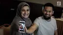 Teuku Wisnu bersama istrinya Shireen Sungkar menunjukkan foto anak ketiganya saat jumpa pers di RS Pondok Indah, Jakarta, Kamis (19/4). Anak ketiga Shireen dan Wisnu ini berjenis kelamin perempuan. (Liputan6.com/Faizal Fanani)