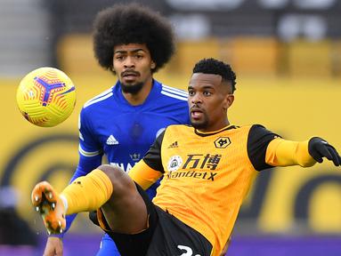 Bek Wolverhampton Wanderers, Nelson Semedo (kanan) menguasai bola dibayangi gelandang Leicester City, Hamza Choudhury dalam laga lanjutan Liga Inggris 2020/21 pekan ke-23 di Molineux Stadium, Minggu (7/2/2021). Wolverhampton bermain imbang 0-0 dengan Leicester. (AFP/Justin Tallis/Pool)