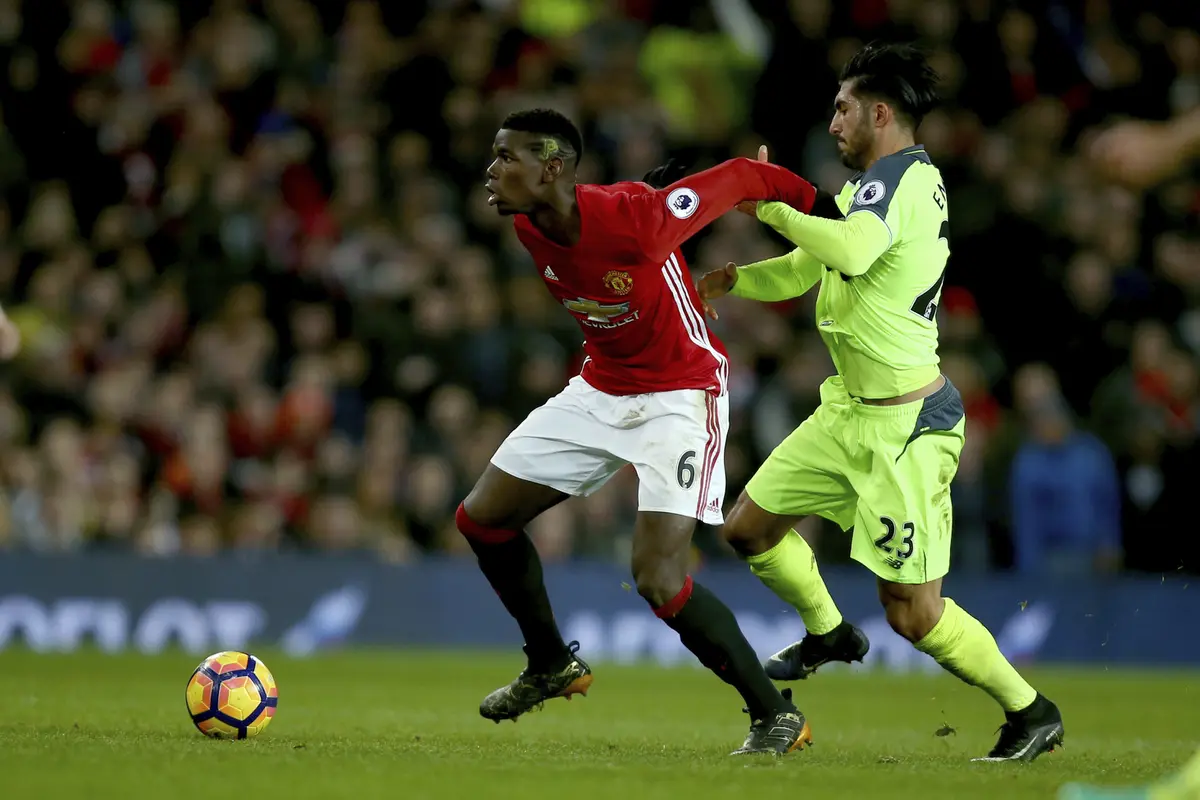 Gelandang Manchester United (MU), Paul Pogba sedang berduel dengan pemain Liverpool, Emre Can. (AP Photo/Dave Thompson)