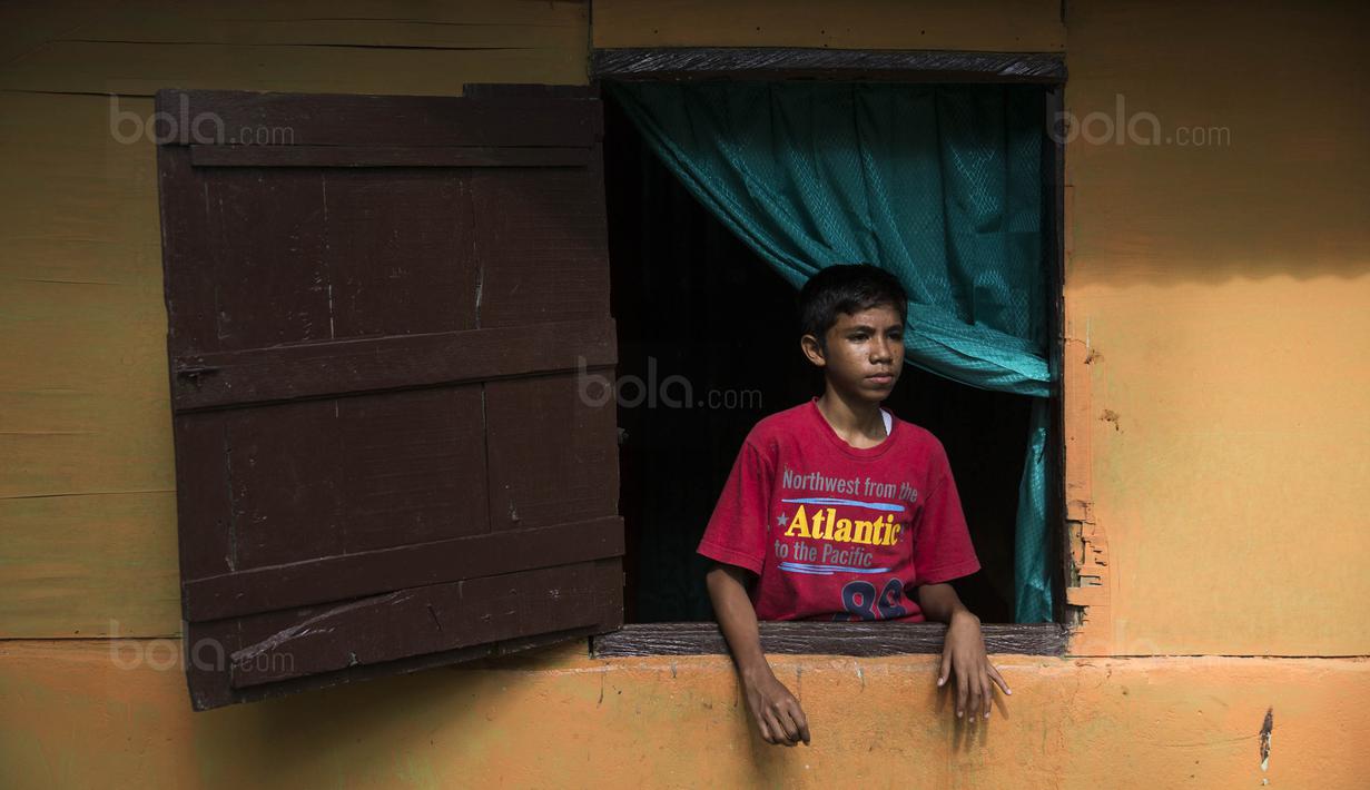Pesepak bola SSB Tulehu Putra, Rizki Lestaluhu, saat berada di rumahnya di Tulehu, Maluku, Selasa (15/11/2017). Pekerjaan sang ayah sebagai pengendara ojek, membuat ekonomi keluarga Rizki tidak terlalu baik. (Bola.com/Vitalis Yogi Trisna)