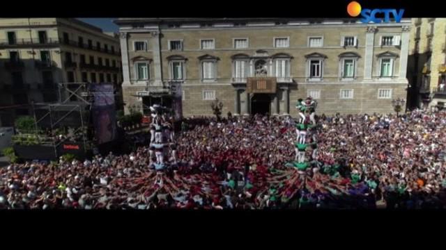 Lapangan Saint James di Barcelona, Spanyol, dipadati ribuan orang. Mereka menonton aksi para castellers,  kelompok piramida manusia.