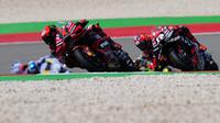 Pebalap Ducati Lenovo, Francesco Bagnaia (kiri) memacu motonya diikuti pebalap Aprilia Racing, Maverick Vinales pada balapan MotoGP Portugal 2023 di Sirkuit Internasional Algarve, Portimao, Portugal, Minggu (26/3/2023). (AP Photo/Jose Breton)