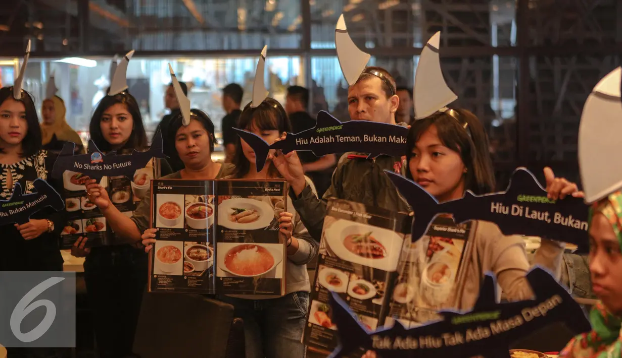 Sejumlah aktivis Greenpeace Indonesia menggelar kampanye selamatkan hiu (savesharks) di salah satu rumah makan, Jakarta, Minggu (12/7/2015). Aksi tersebut sebagai upaya menyelamatkan hiu dari kepunahan. (Liputan6.com/Faizal Fanani)