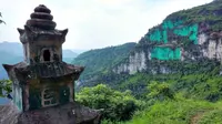 Yang Zhigang mengecat dinding gunung dengan warna hijau terang karena percaya warna asli gunung itu memberikan pengaruh negatif