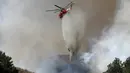 Helikopter membantu memadamkan api yang melanda Hutan Nasional Angeles dekat Los Angeles, California, AS (24/7). Setidaknya terdapat 300 orang yang telah dievakuasi oleh pihak berwenang ke tempat yang lebih aman, di luar kota. (REUTERS / Jonathan Alcorn)
