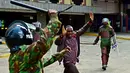 Polisi Kenya berusaha memukul seorang pengunjuk rasa saat bentrok di Nairobi, Kenya (16/5/2016). Mereka menuntut pembubaran otoritas pemilu karena adanya dugaan korupsi. (AFP PHOTO/ CARL DE SOUZA)