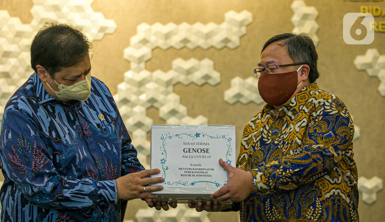 Menristek Bambang Brodjonegoro (kanan) memberikan GeNose C19 kepada Menko Bidang Perekonomian Airlangga Hartarto di Gedung Kemenko Perekonomian, Jakarta, Senin (22/3/2021). GeNose C19 diharapkan dapat semakin dikenal dan dimanfaatkan secara lebih masif. (Liputan6.com/Faizal Fanani)