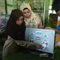 Dicky dan Haya, siswa MTSN 8 Sragen Kalijambe Sragen didampingi Kepala Sekolah Muawanatul Badriyah memeragakan cara kerja ATM Pembagi Sembako. (Foto: Liputan6.com/joglosemarnews.com/Wardoyo)