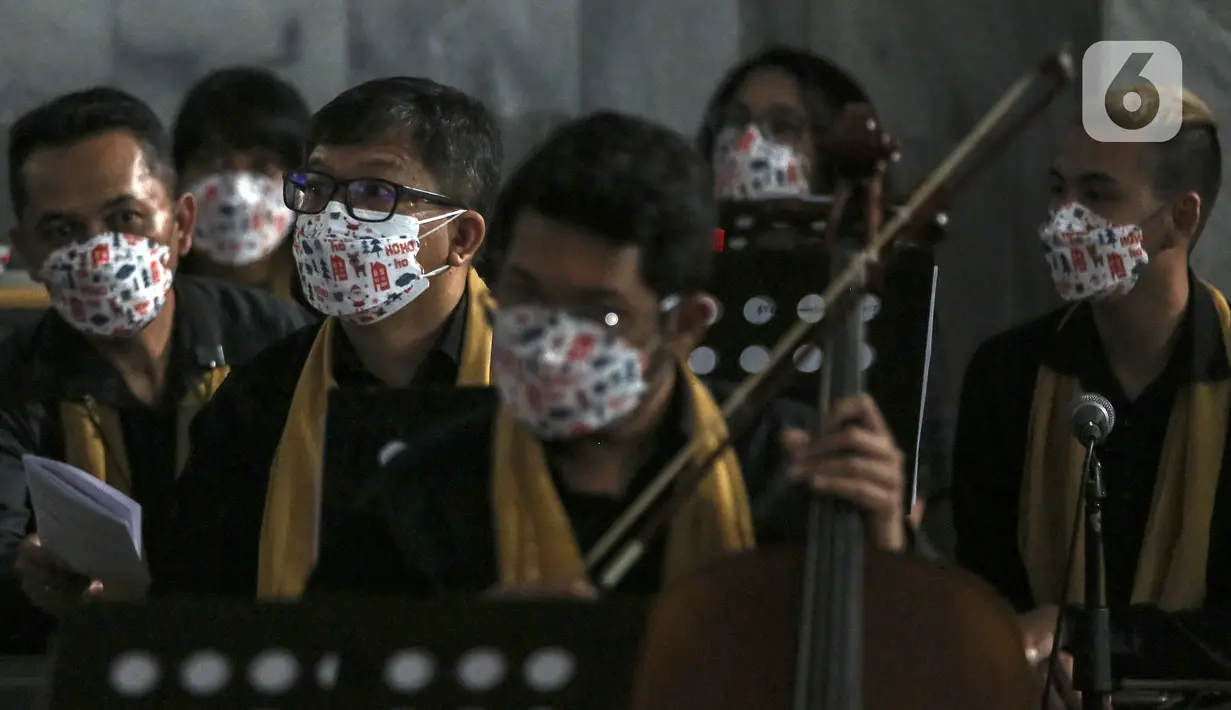 Musikus mengiringi ibadah perayaan malam Natal di Gereja Protestan Indonesia Bagian Barat (GPIB) Effatha, Jakarta, Jumat (24/12/2021). Ibadah malam ini membawa pesan untuk terus berpengharapan dan bersukacita di tengah situasi yang sulit karena pandemi COVID-19. (Liputan6.com/Johan Tallo)