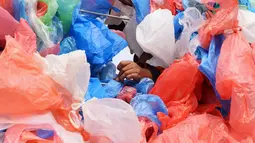 Relawan Nepal mengikat kantong plastik daur ulang membentuk replika Laut Mati di Kathmandu pada 5 Desember 2018. Kegiatan ini diharap dapat meningkatkan kesadaran masyarakat akan banyaknya sampah plastik yang mencemari lautan dunia (PRAKASH MATHEMA / AFP)