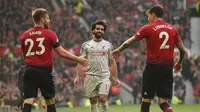 Bek Manchester United (MU) Luke Shaw dan Victor Lindelof (kanan) sukses menghentikan bintang Liverpool Mohamed Salah pada laga Liga Inggris di Old Trafford, Minggu (24/2/2019). (AFP/Oli Scarff)