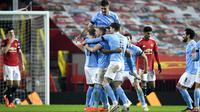Para pemain Manchester City merayakan gol ke gawang Manchester United pada pertandingan semifinal Piala Liga Inggris di Old Trafford, Manchester, Inggris, Rabu (6/1/2021). Manchester City melaju ke final Piala Liga Inggris usai mengalahkan MU 2-0. (Peter Powell/Pool via AP)