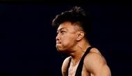 Pada angkatan snatch, Rahmat Abdullah berhasil menorehkan angkatan terbaik 158 kg. (Ishara S.KODIKARA / AFP)
