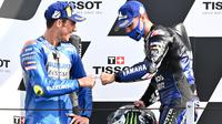 Pembalap Monster Energy Yamaha, Maveric Vinales (kanan) dan rider Suzuki, Joan Mir, pada balapan MotoGP Emilia Romagna, di Sirkuit Misano, Minggu (20/9/2020). (AFP/Andreas Sorano)