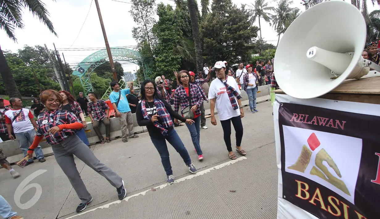 Massa pendukung Ahok berjoget di depan Gedung Kementrian Pertanian, Jakarta Selatan, Rabu (29/3). Dalam sidang ke-16 tersebut tim kuasa hukum menghadirkan 7 saksi ahli untuk meringankan Ahok. (Liputan6.com/Immanuel Antonius)