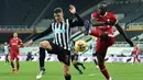 Bek Newcastle United, Ciaran Clark (kiri) berebut bola dengan striker Liverpool, Sadio Mane dalam laga lanjutan Liga Inggris 2020/21 pekan ke-16 di St James' Park, Rabu (30/12/2020). Newcastle United bermain imbang 0-0 dengan Liverpool. (AFP/Peter Powell/Pool)