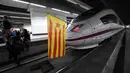 Sebuah bendera pro-kemerdekaan Catalonia ditempatkan di sebuah kereta oleh para pemrotes yang memblokir jalur di Stasiun Sants di Barcelona (8/11). (AFP Photo/Lluis Gene)