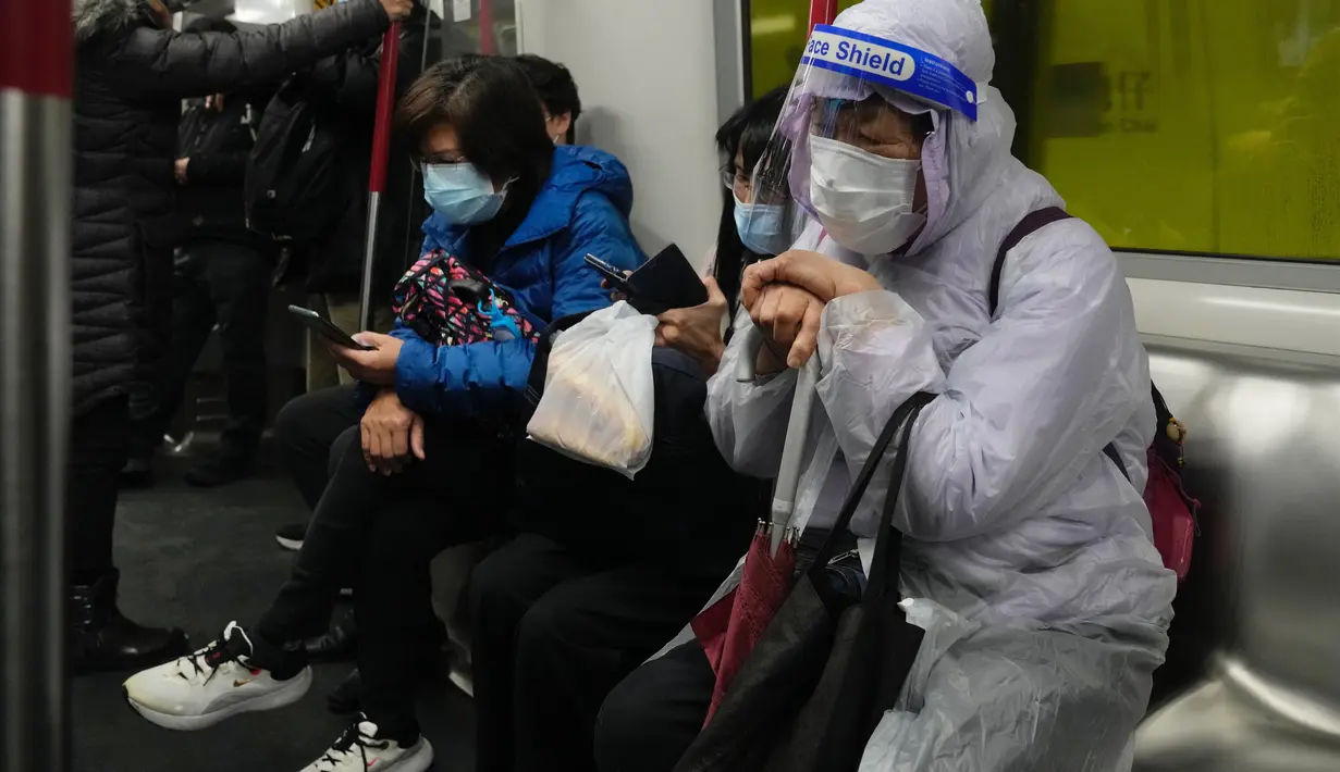 Penumpang mengenakan masker dan pelindung wajah, duduk di kereta di Hong Kong, 23 Februari 2022. Warga Hong Kong semakin kesal dengan desakan pemerintah untuk tetap berpegang pada strategi "nol-COVID" ketika kota itu mencatat rekor jumlah kasus baru lainnya pada hari Rabu. (AP Photo/Vincent Yu)