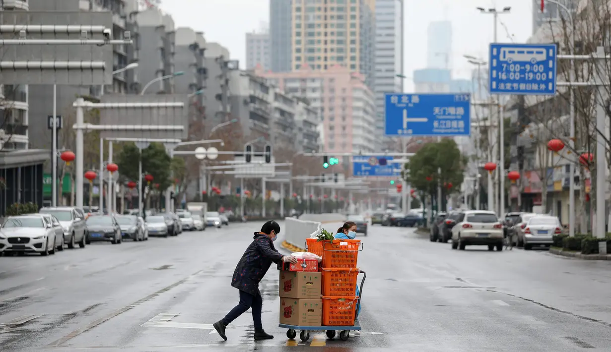 Warga membawa makanan dan sayuran di Wuhan di provinsi Hubei tengah China (3/3/2020). Hingga saat ini, jumlah total kasus virus corona secara global dilaporkan mencapai 89.770 kasus yang tersebar di sekitar 70 negara termasuk Indonesia. (AFP/STR)