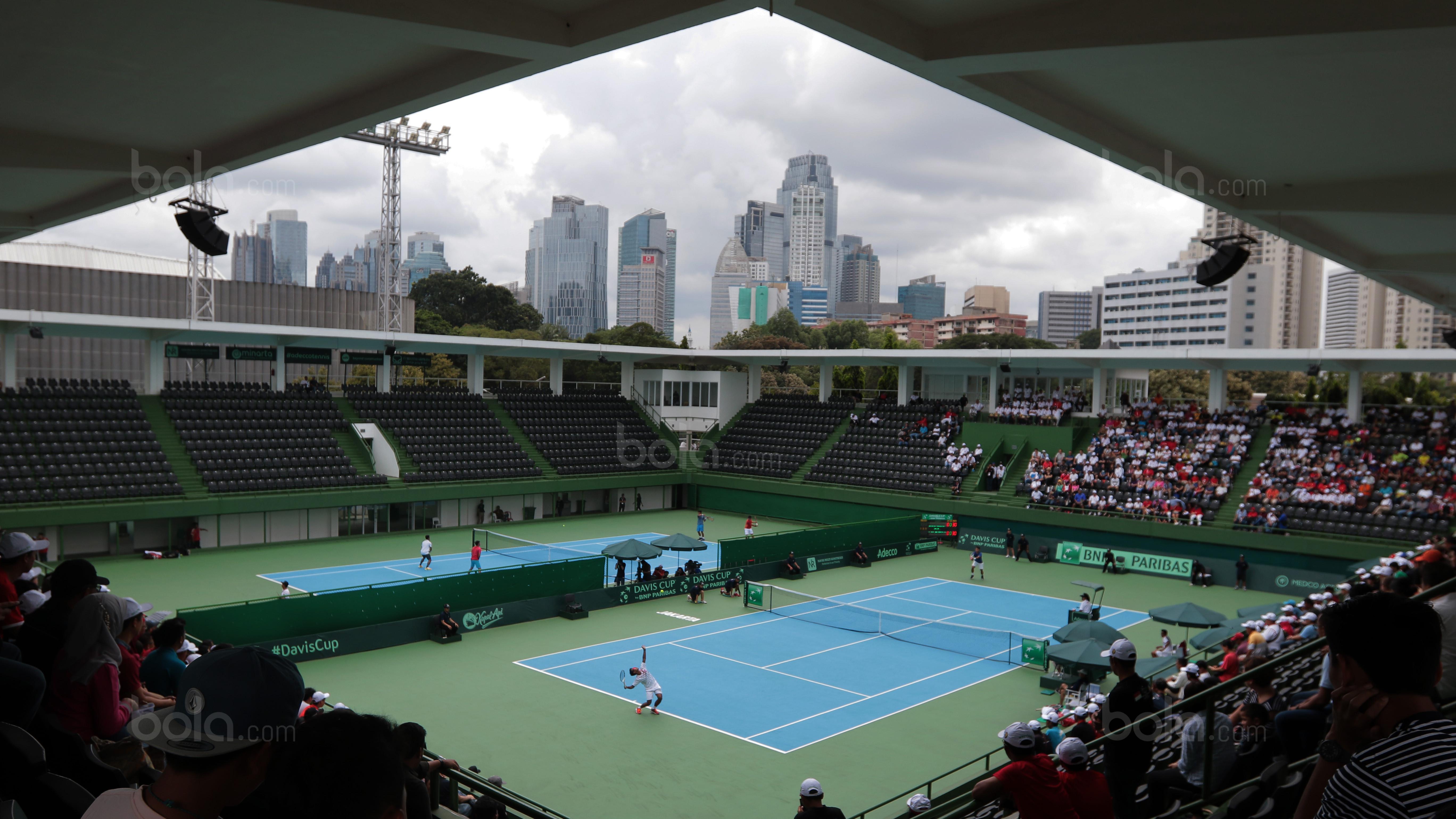Aksi petenis Indonesia, Althaf Dhaifullah melakukan servis saat melawan petenis Fiipina Davis 2018 grup dua Asia/Oceania di Senayan, Jakarta, Sabtu (3/2/2018). Althaf kalah 3-6, 2-6. (Bola.com/Nick Hanoatubun)